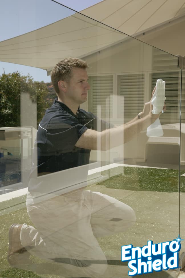 Aquashield Bathrooms - Enduroshield being applied to a glass pool fence